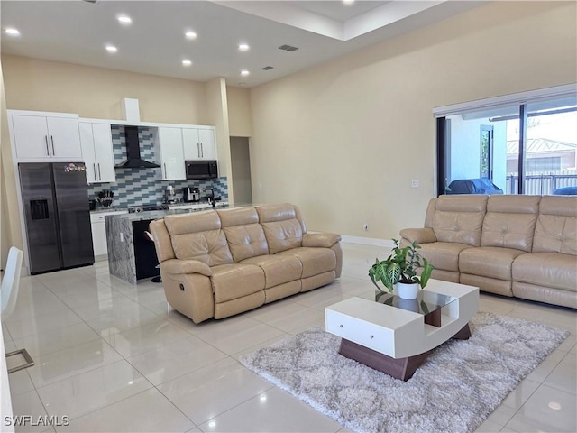 living area with recessed lighting, light tile patterned flooring, and baseboards