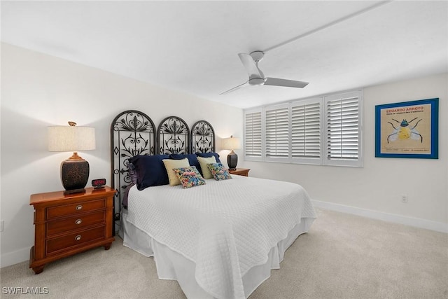 carpeted bedroom with baseboards and a ceiling fan