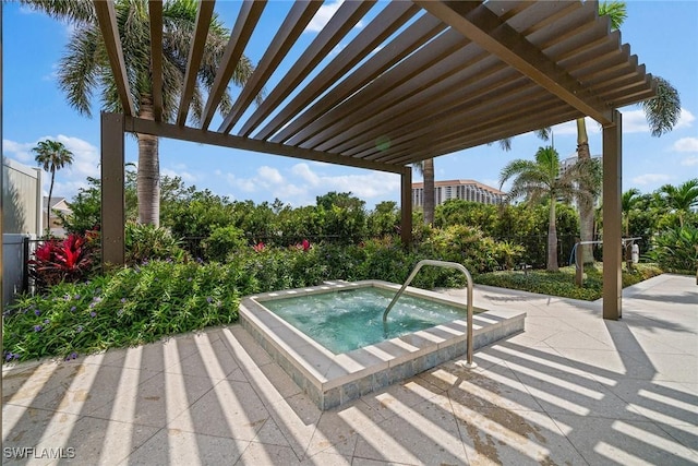 view of pool with a patio area and an in ground hot tub