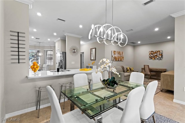 dining room featuring ornamental molding, visible vents, and an inviting chandelier