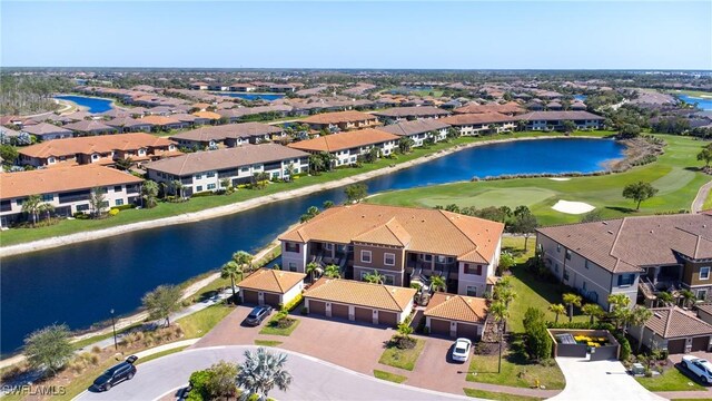 drone / aerial view featuring a residential view and a water view