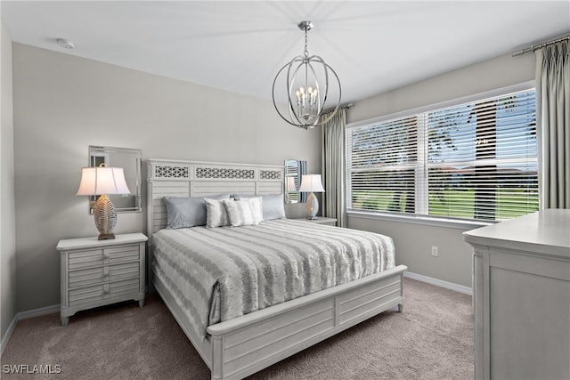 carpeted bedroom with a chandelier and baseboards