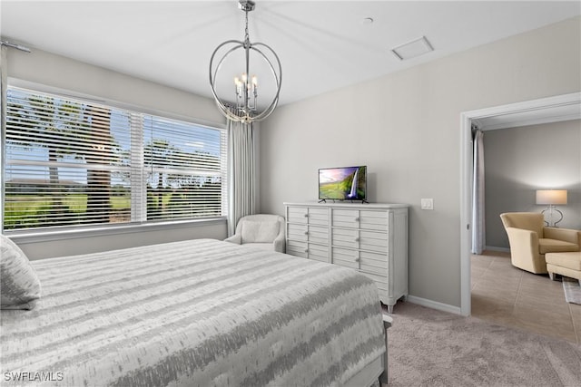 bedroom featuring a chandelier, carpet flooring, and baseboards