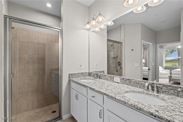 bathroom with a shower stall, double vanity, a sink, and connected bathroom