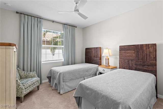 carpeted bedroom featuring a ceiling fan and baseboards