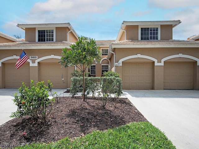 view of front facade featuring concrete driveway and stucco siding