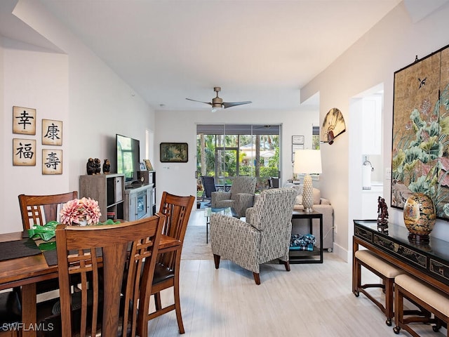 dining space with light wood-style flooring and a ceiling fan