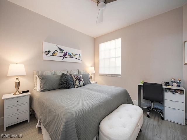 bedroom with baseboards, ceiling fan, and wood finished floors