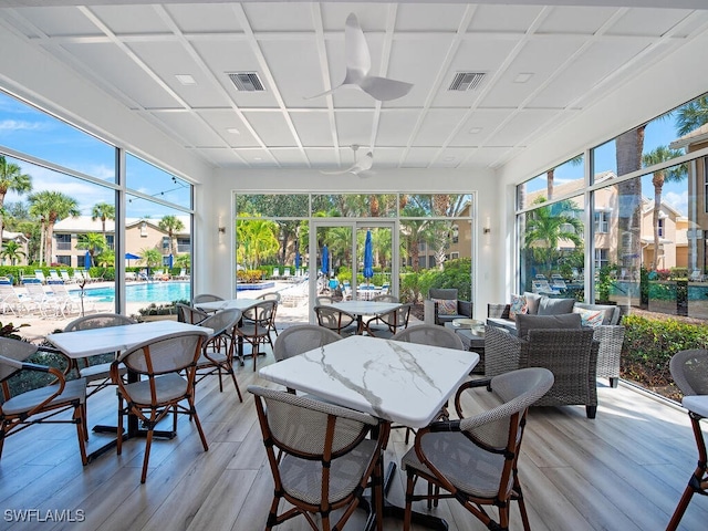 sunroom / solarium with visible vents and ceiling fan