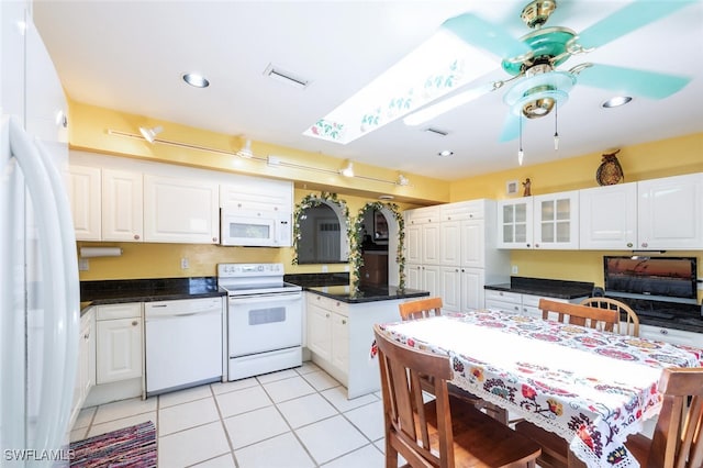 kitchen with white cabinetry, white appliances, and light tile patterned floors