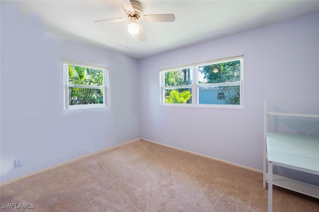 empty room with baseboards, a ceiling fan, and carpet flooring