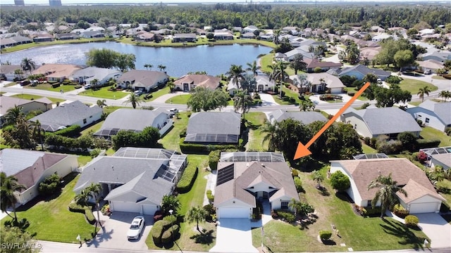 birds eye view of property with a residential view and a water view