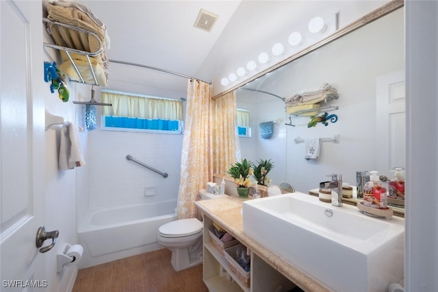 full bathroom featuring wood finished floors, visible vents, lofted ceiling, toilet, and shower / tub combo with curtain