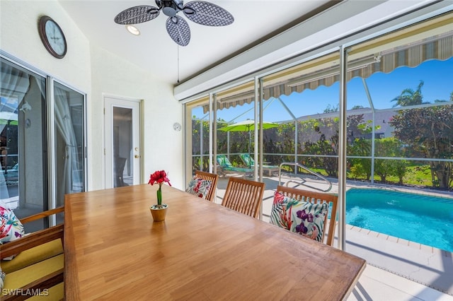 sunroom / solarium with vaulted ceiling and a ceiling fan