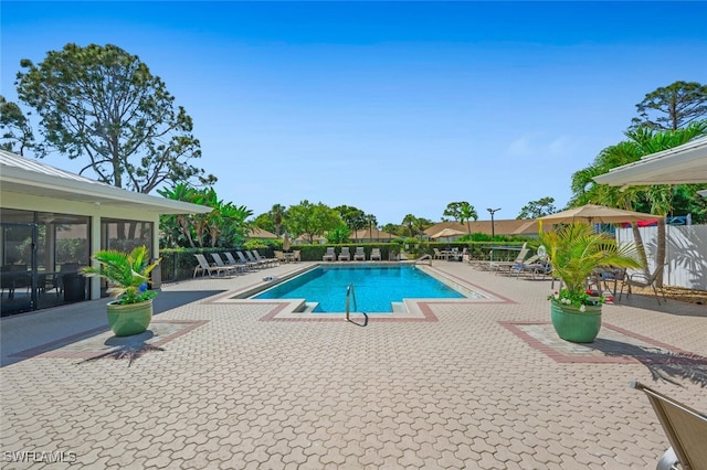 community pool featuring a patio and fence