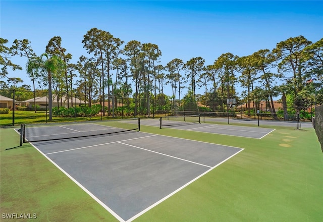 view of tennis court with fence