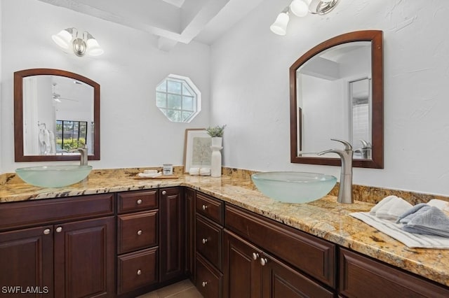 full bathroom featuring double vanity, a wealth of natural light, and a sink