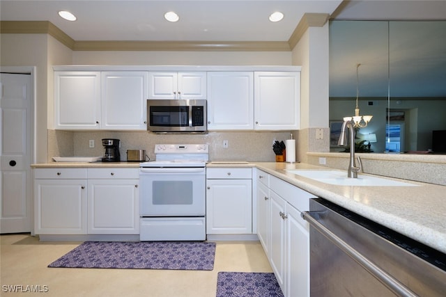 kitchen with appliances with stainless steel finishes, white cabinetry, and decorative backsplash