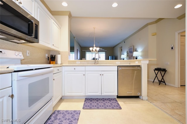 kitchen featuring stainless steel appliances, recessed lighting, ornamental molding, white cabinets, and a peninsula