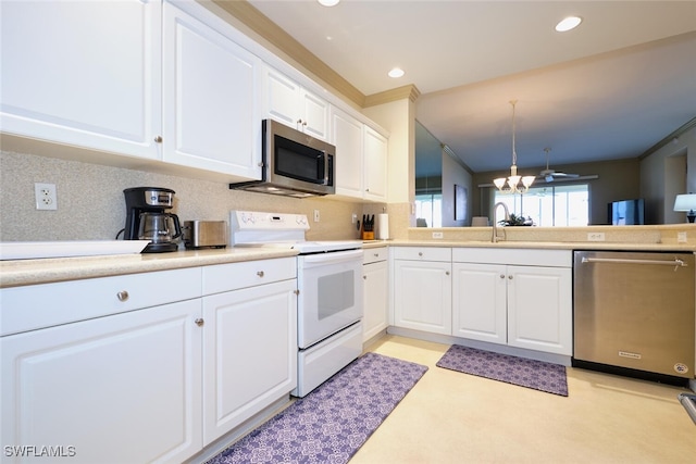 kitchen featuring light countertops, decorative backsplash, appliances with stainless steel finishes, white cabinetry, and a sink