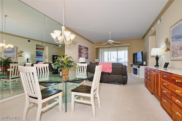 dining space with ornamental molding, visible vents, light carpet, and ceiling fan with notable chandelier