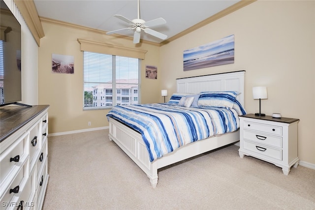 bedroom with a ceiling fan, baseboards, crown molding, and light colored carpet