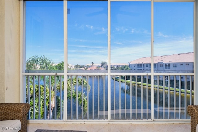 unfurnished sunroom with a water view