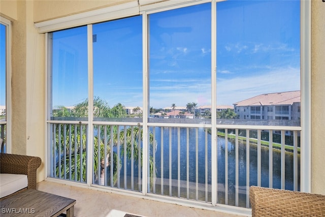 unfurnished sunroom with a water view