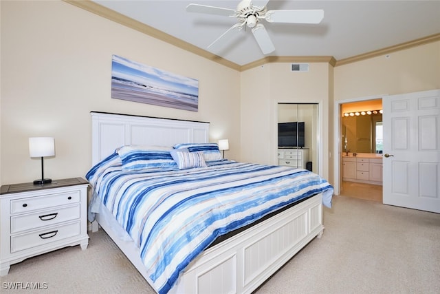 bedroom with ceiling fan, light colored carpet, visible vents, ensuite bath, and crown molding