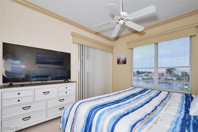 bedroom with ornamental molding, a ceiling fan, and light colored carpet