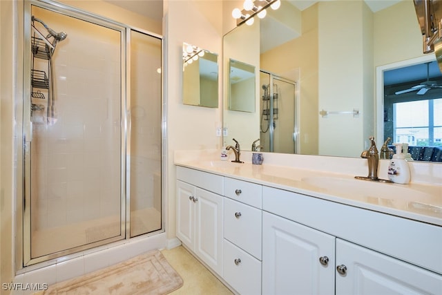 bathroom featuring a sink, double vanity, and a shower stall