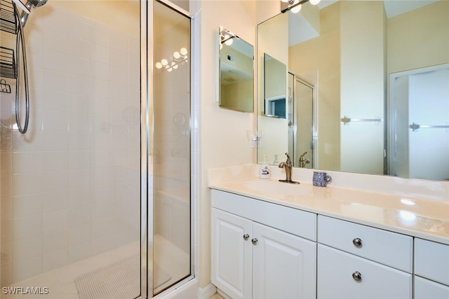 bathroom with a shower stall and vanity