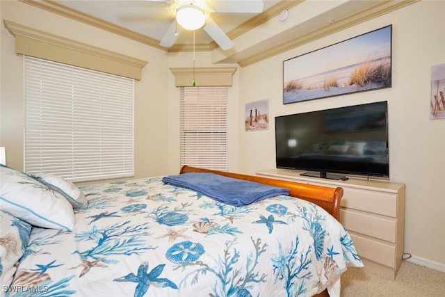 carpeted bedroom featuring ornamental molding, baseboards, and a ceiling fan