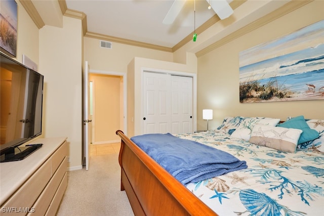 bedroom with ornamental molding, a closet, visible vents, and light carpet