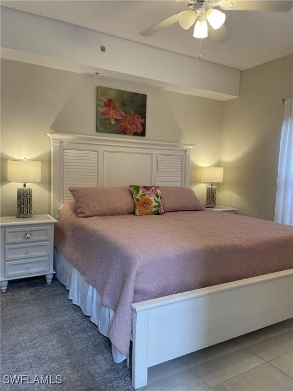 tiled bedroom featuring ceiling fan