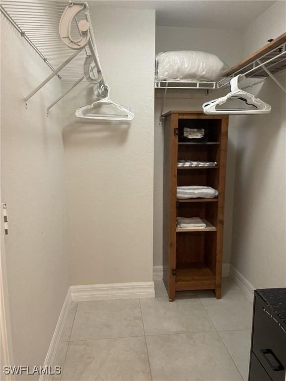 spacious closet featuring light tile patterned floors