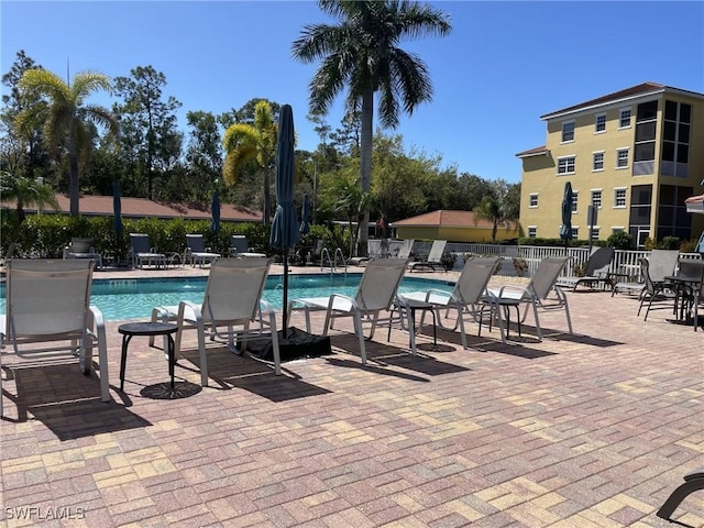 pool featuring a patio and fence