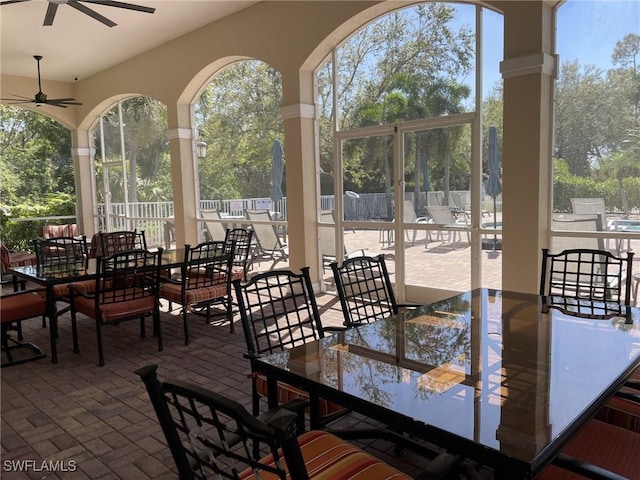 view of patio / terrace with outdoor dining area, a ceiling fan, and fence