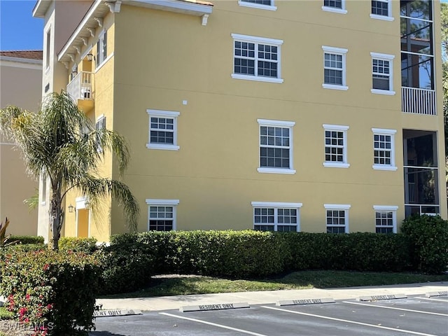 view of property featuring uncovered parking