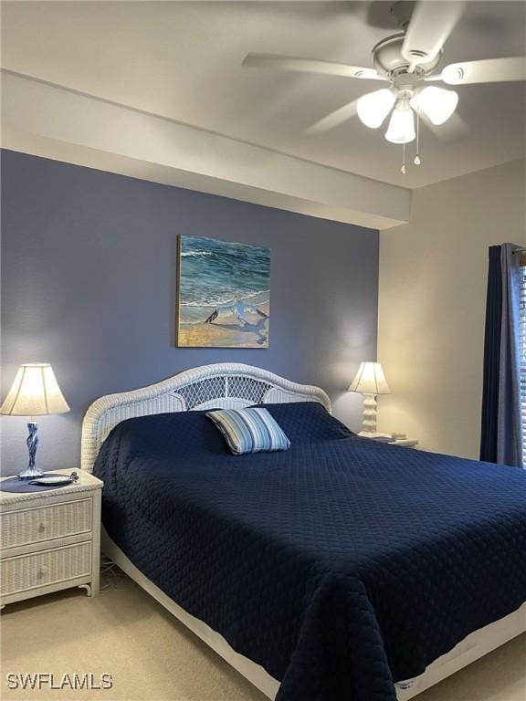 bedroom featuring light colored carpet and a ceiling fan