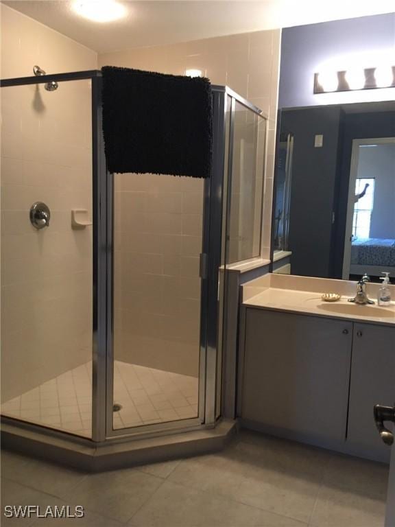 bathroom featuring vanity, tile patterned floors, and a stall shower