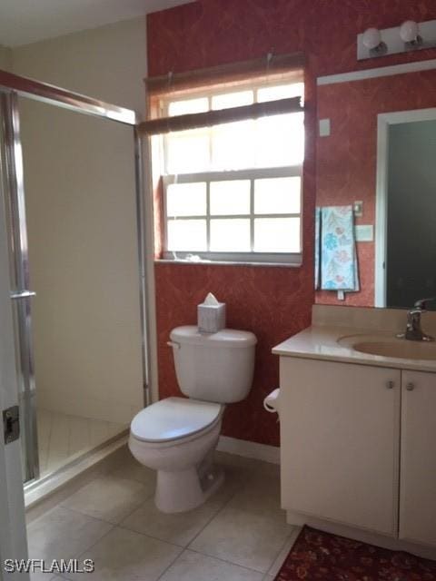 full bathroom with tile patterned floors, a stall shower, toilet, and vanity