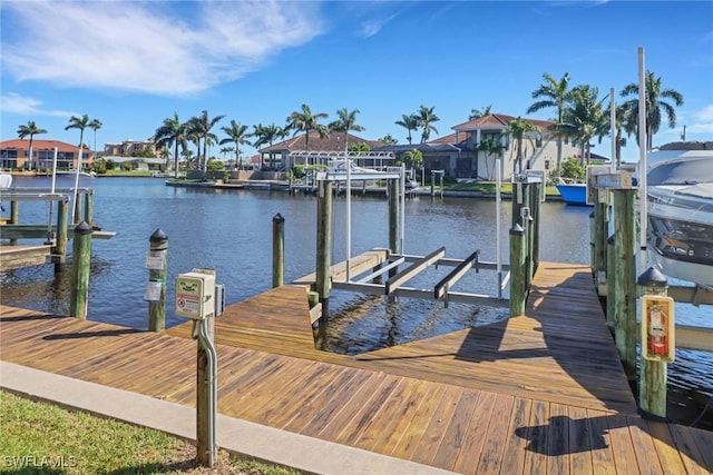 dock area featuring a water view, a residential view, and boat lift