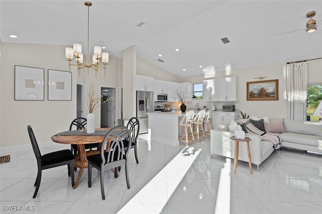 dining room featuring an inviting chandelier, a healthy amount of sunlight, visible vents, and marble finish floor