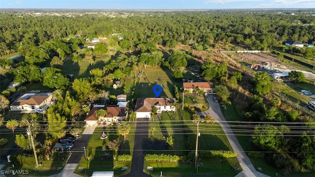 bird's eye view featuring a wooded view