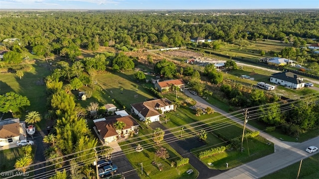 drone / aerial view featuring a forest view