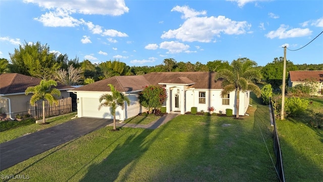 view of front of home with fence, aphalt driveway, a front yard, stucco siding, and an attached garage