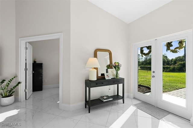 interior space featuring a wealth of natural light, marble finish floor, french doors, and baseboards