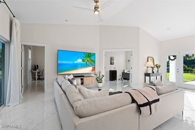 living room with marble finish floor, lofted ceiling, and a ceiling fan