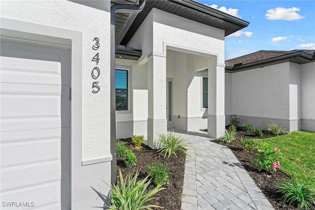 entrance to property with stucco siding